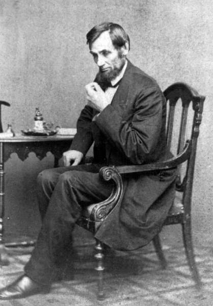 Abraham Lincoln seated at a small table, May 16, 1861, Brady photograph