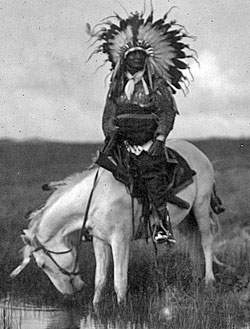 Cheyenne warrior chief on horseback, posed recreation, circa 1905